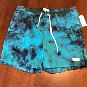Teal tie-dye swim trunks.